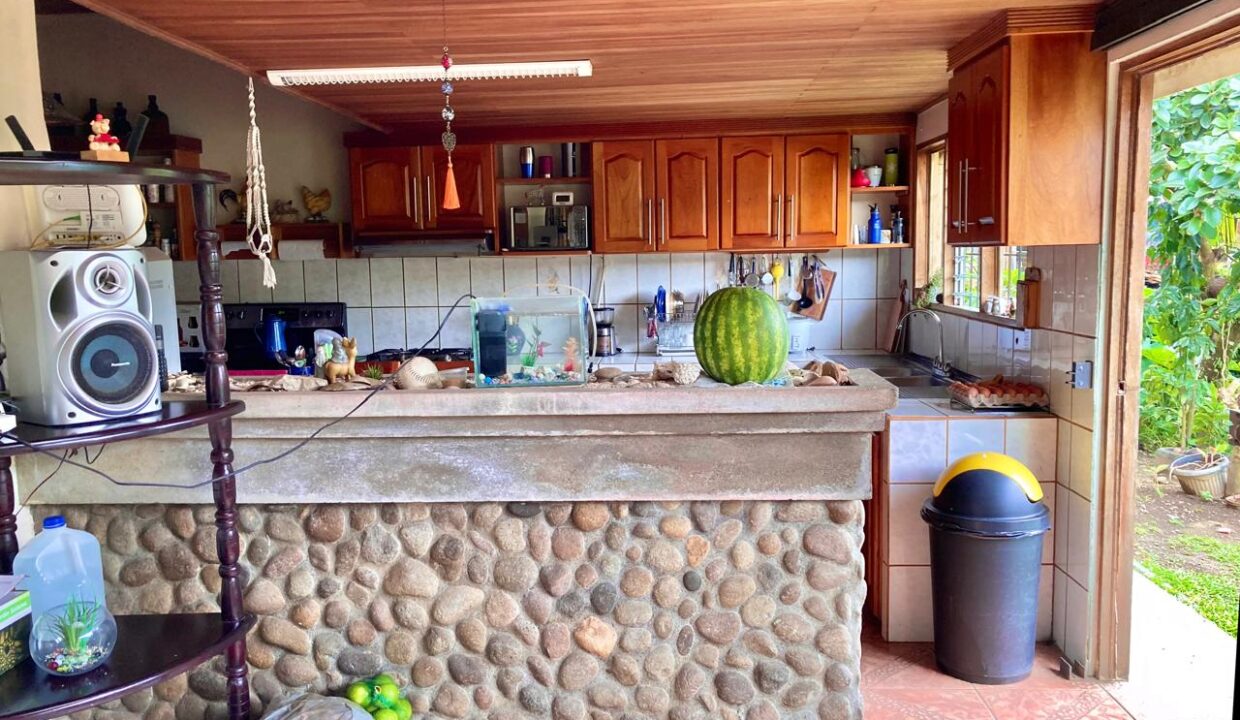 Spacious open-concept cedar kitchen stone counter