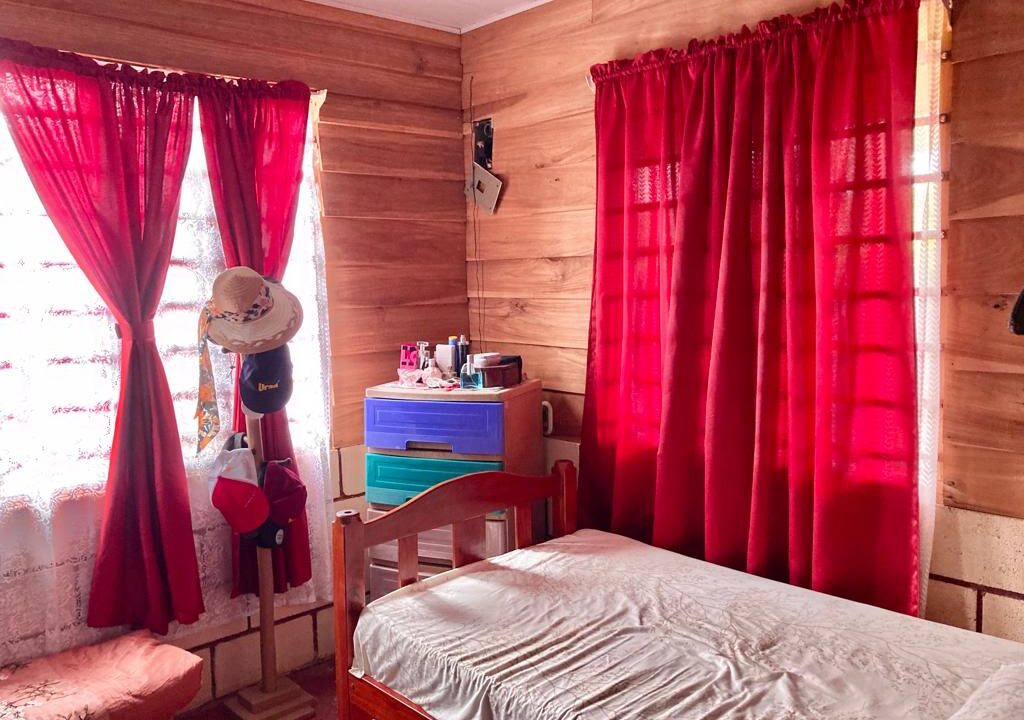 Second bedroom with red curtains in La Fortuna Costa Rica real estate