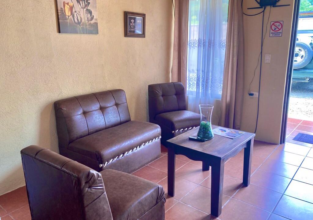 Tropical Glow living room with sofa in furnished rental home near Arenal Volcano in La Fortuna Costa Rica