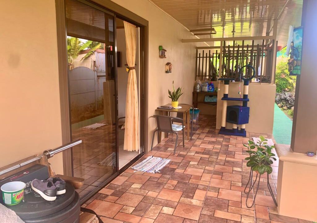 Tropical Glow Costa Rica real estate with shaded sitting area and sliding glass doors