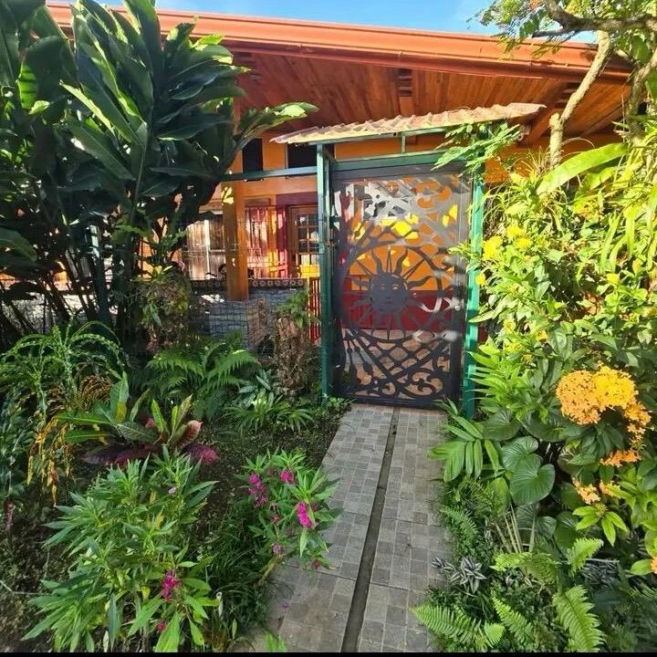 garden and Artistic Front Gate of La Fortuna Duplex – Secure and Stylish Airbnb Investment