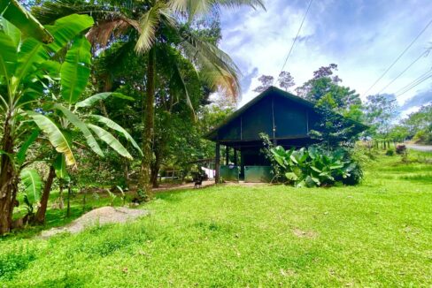 Rustic wooden house with tropical trees and sunny skies in La Fortuna Costa Rica