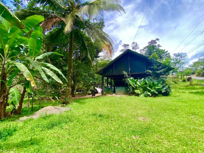 Rustic wooden house with tropical trees and sunny skies in La Fortuna Costa Rica