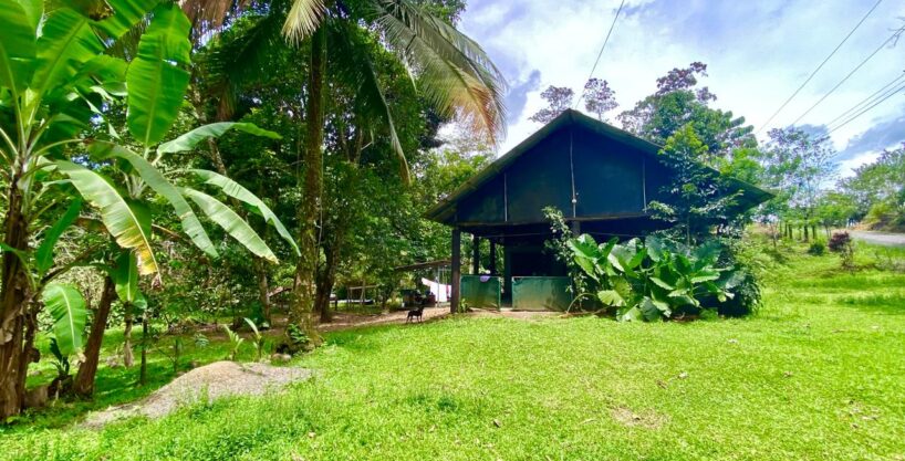 Rustic wooden house with tropical trees and sunny skies in La Fortuna Costa Rica