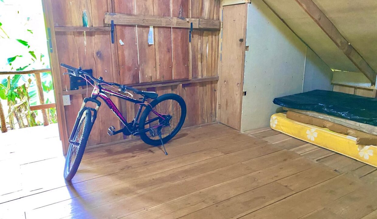 Upper-level bedroom with balcony access and forest scenery near Arenal Volcano – La Fortuna Costa Rica – Tropical Glow