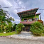 Modern green triplex with private balconies and lush garden landscaping in La Fortuna Costa Rica real estate near Arenal Volcano and hot springs