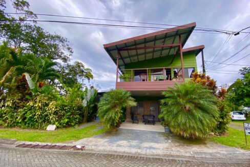 Modern green triplex with private balconies and lush garden landscaping in La Fortuna Costa Rica real estate near Arenal Volcano and hot springs