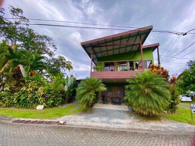 Modern green triplex with private balconies and lush garden landscaping in La Fortuna Costa Rica real estate near Arenal Volcano and hot springs