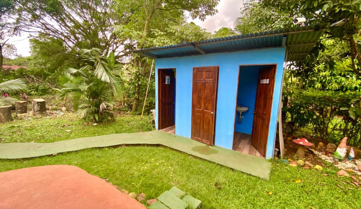 Colorful detached outdoor restroom ideal for poolside use in Chachagua Costa Rica real estate