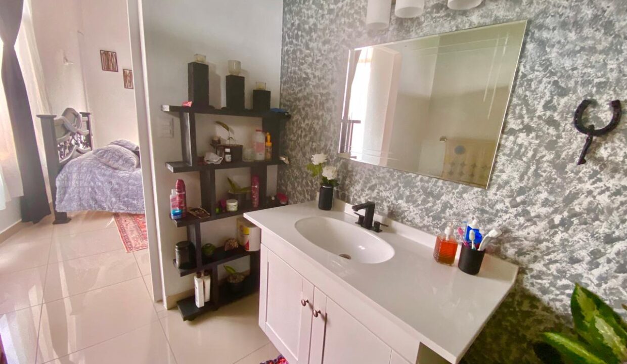 Modern full bathroom with storage, connected to master bedroom in La Fortuna volcano-view penthouse