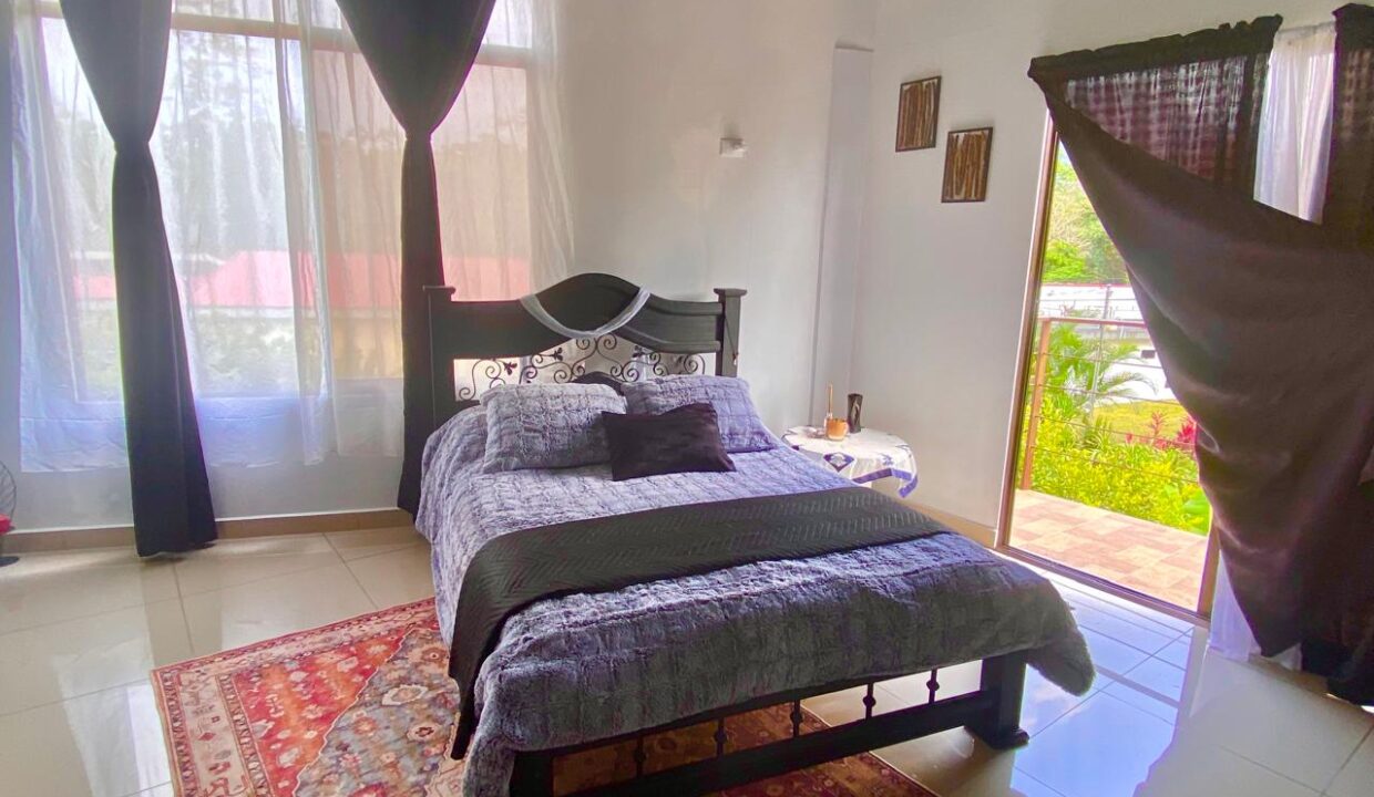 Penthouse master suite with direct access to volcano-view balcony in La Fortuna