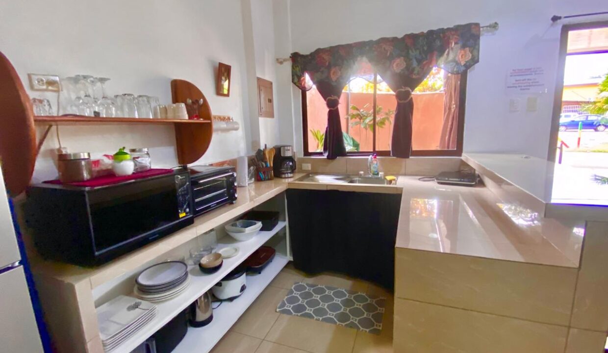 Open kitchen with tiled countertops and cabinetry in La Fortuna Airbnb apartment