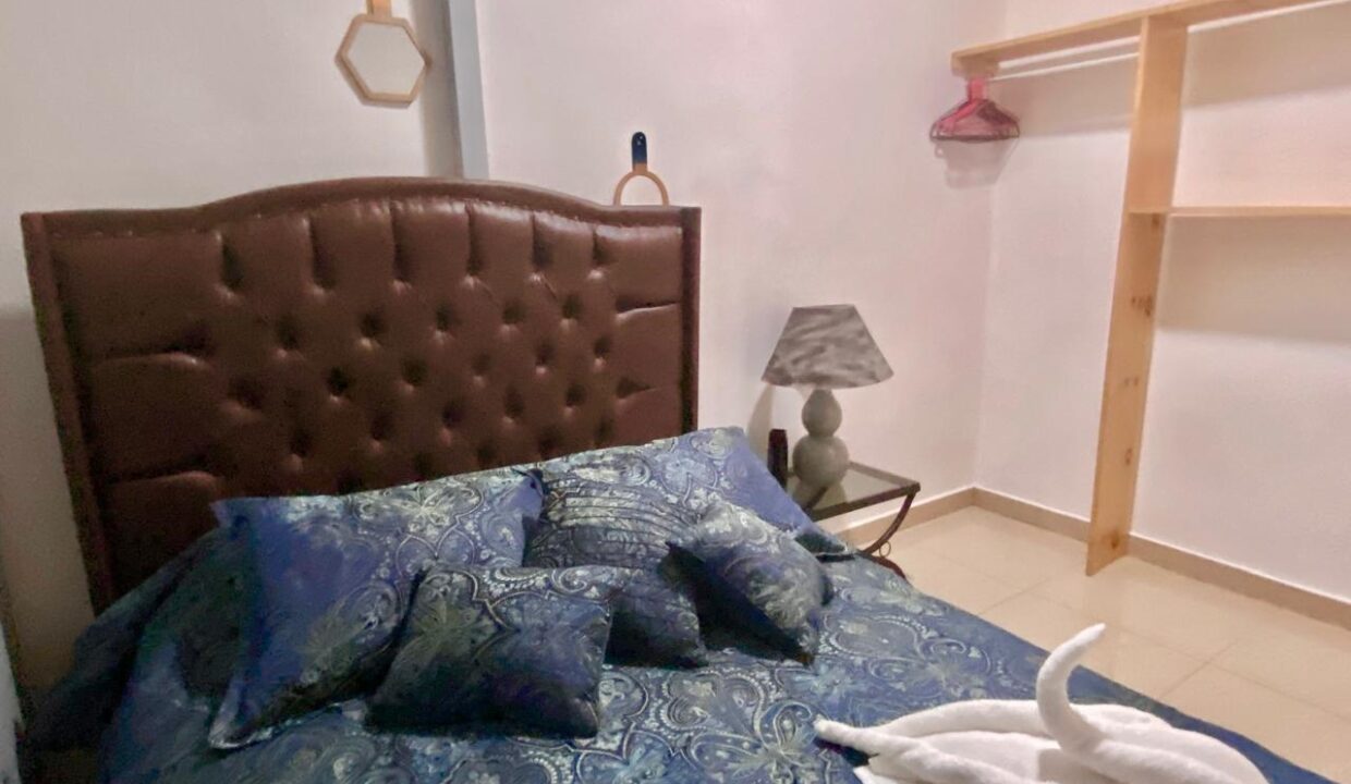 Cozy guest bedroom with storage in La Fortuna Airbnb apartment near hot springs