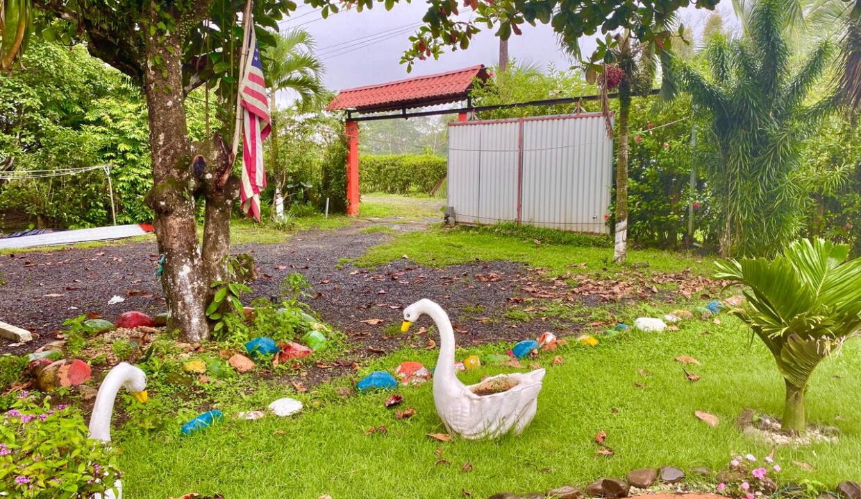 Fully fenced Costa Rica property for sale near La Fortuna with large secure gate and artistic yard