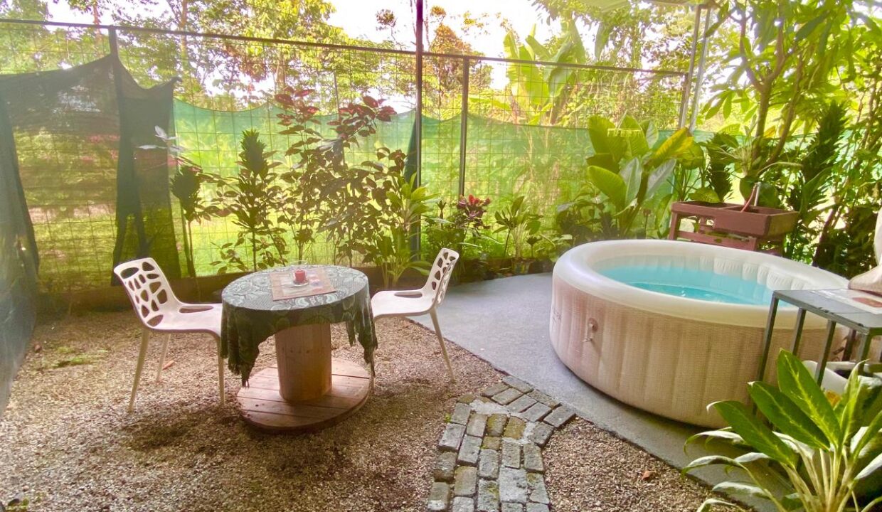 Outdoor jacuzzi with garden views in peaceful corner of La Fortuna triplex property