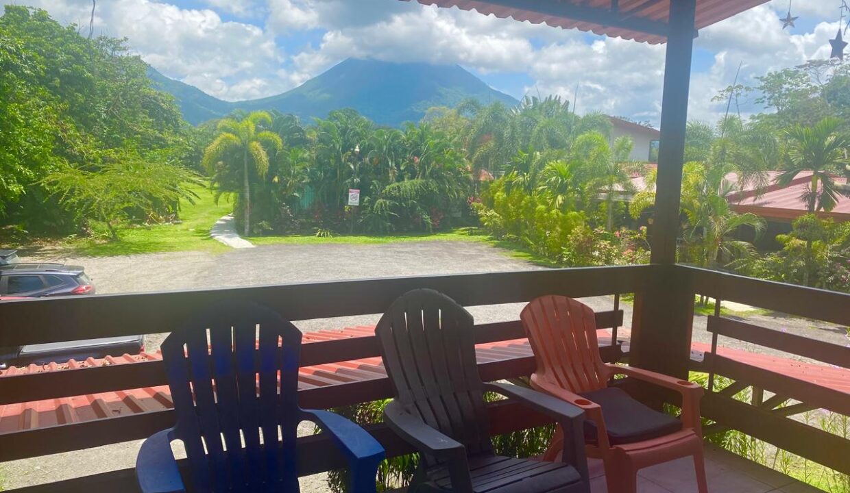 Covered patio with colorful chairs and Arenal Volcano view in La Fortuna, Costa Rica
