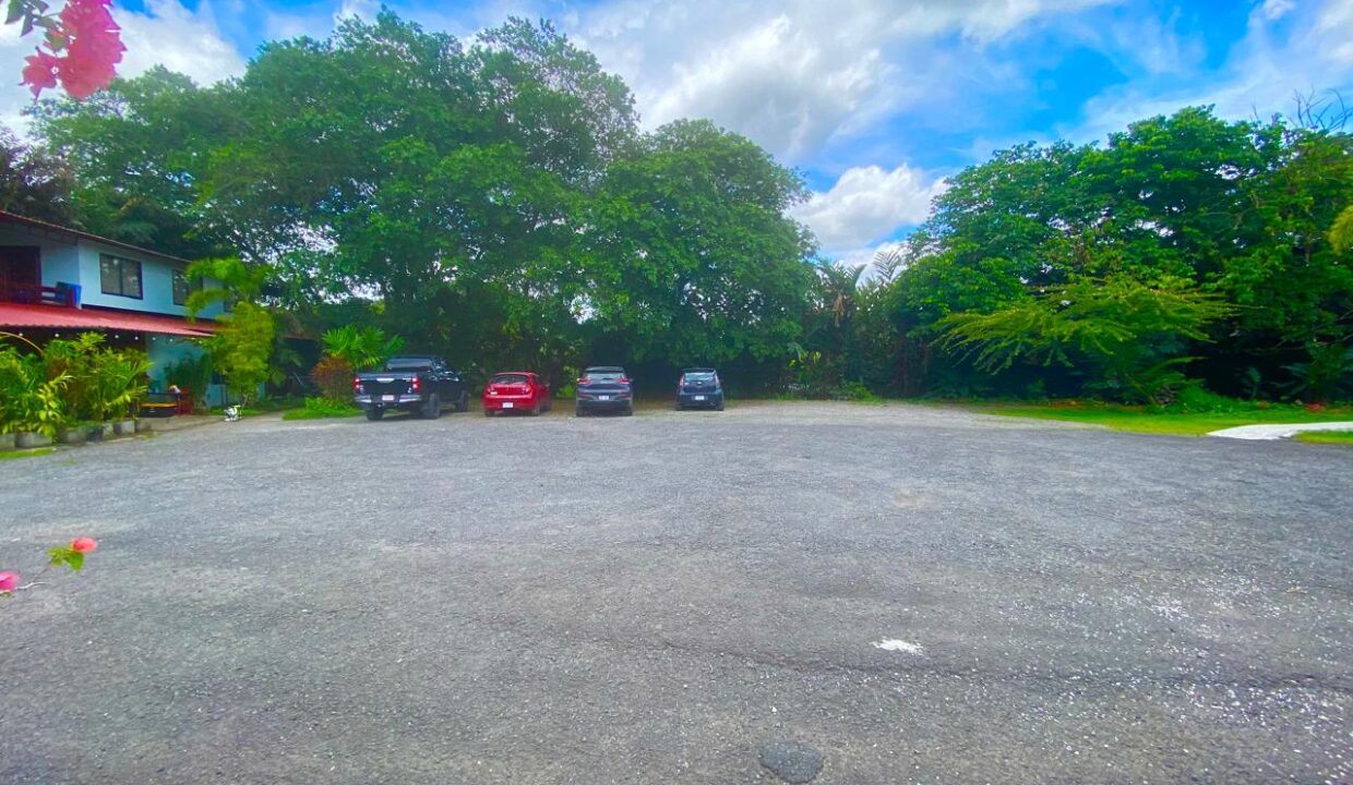 Ample guest parking with mature trees and clear sky view in La Fortuna Costa Rica real estate near Arenal Volcano by Tropical Glow