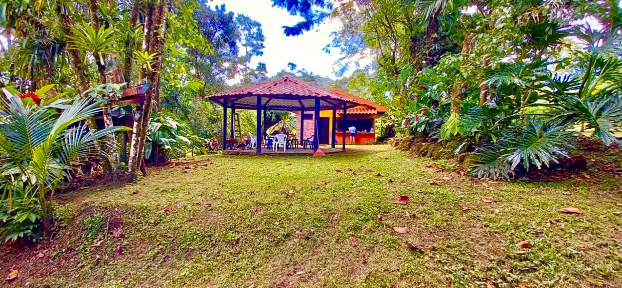 Outdoor rancho and home nestled in lush tropical garden near Arenal Volcano and tourist attractions