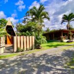 Tropical Glow entrance with A-frame guest cabin and lush gardens in La Fortuna Costa Rica