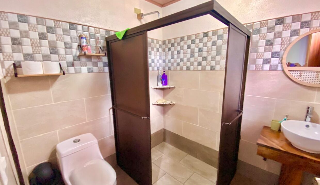 Modern bathroom with handcrafted wood sink counter near Arenal Volcano