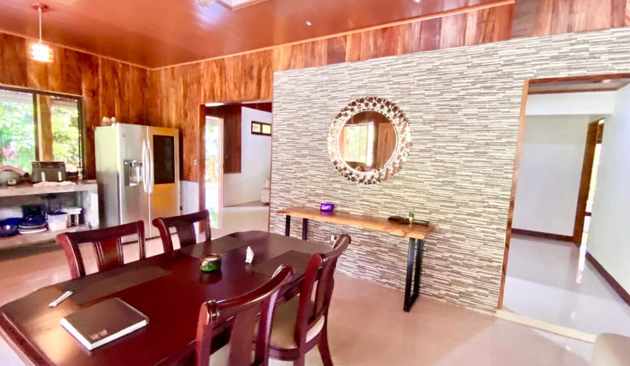 Formal dining room in La Fortuna real estate with natural wood finishes