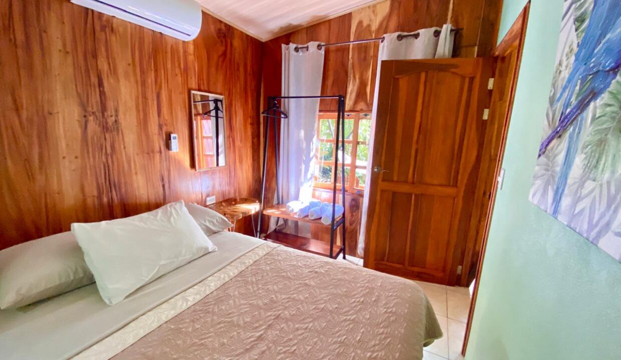 Warm-toned bedroom with air conditioning in tropical Costa Rica home