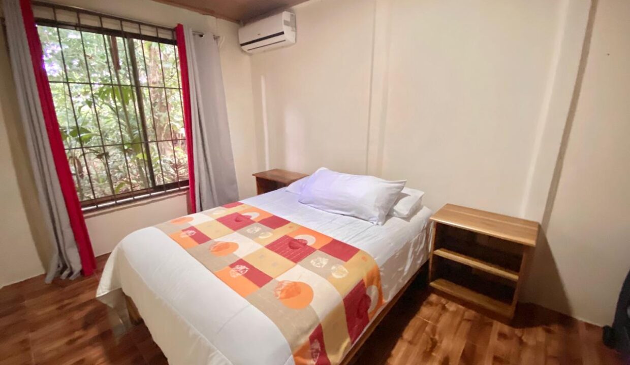 Peaceful bedroom featuring natural light, garden view, and split air conditioning