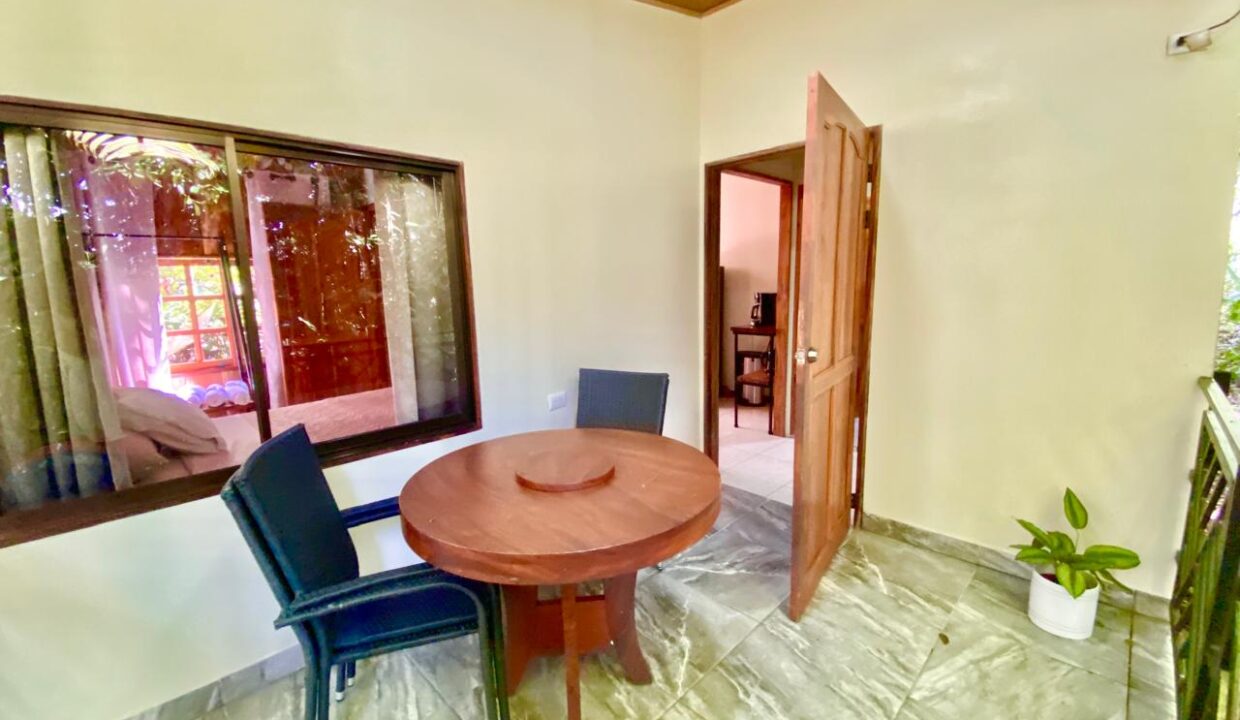 Cozy covered patio with views of the trees in La Fortuna Costa Rica real estate near Arenal Volcano