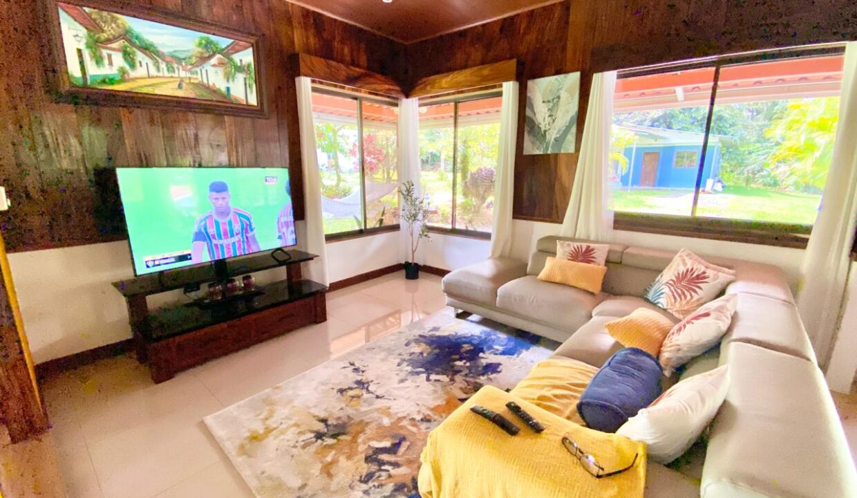 Bright living area with sectional sofa and tropical wood finishes in Costa Rica home