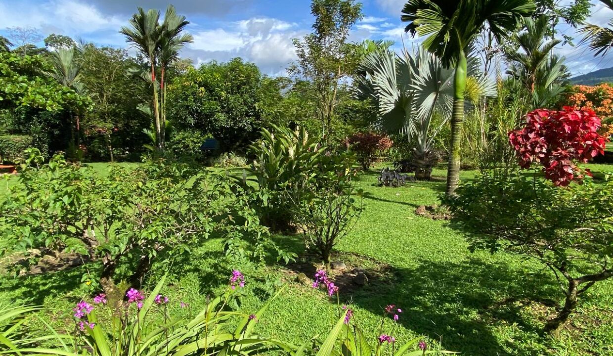 Mature trees and vibrant flowers in La Fortuna Costa Rica real estate near Arenal Volcano