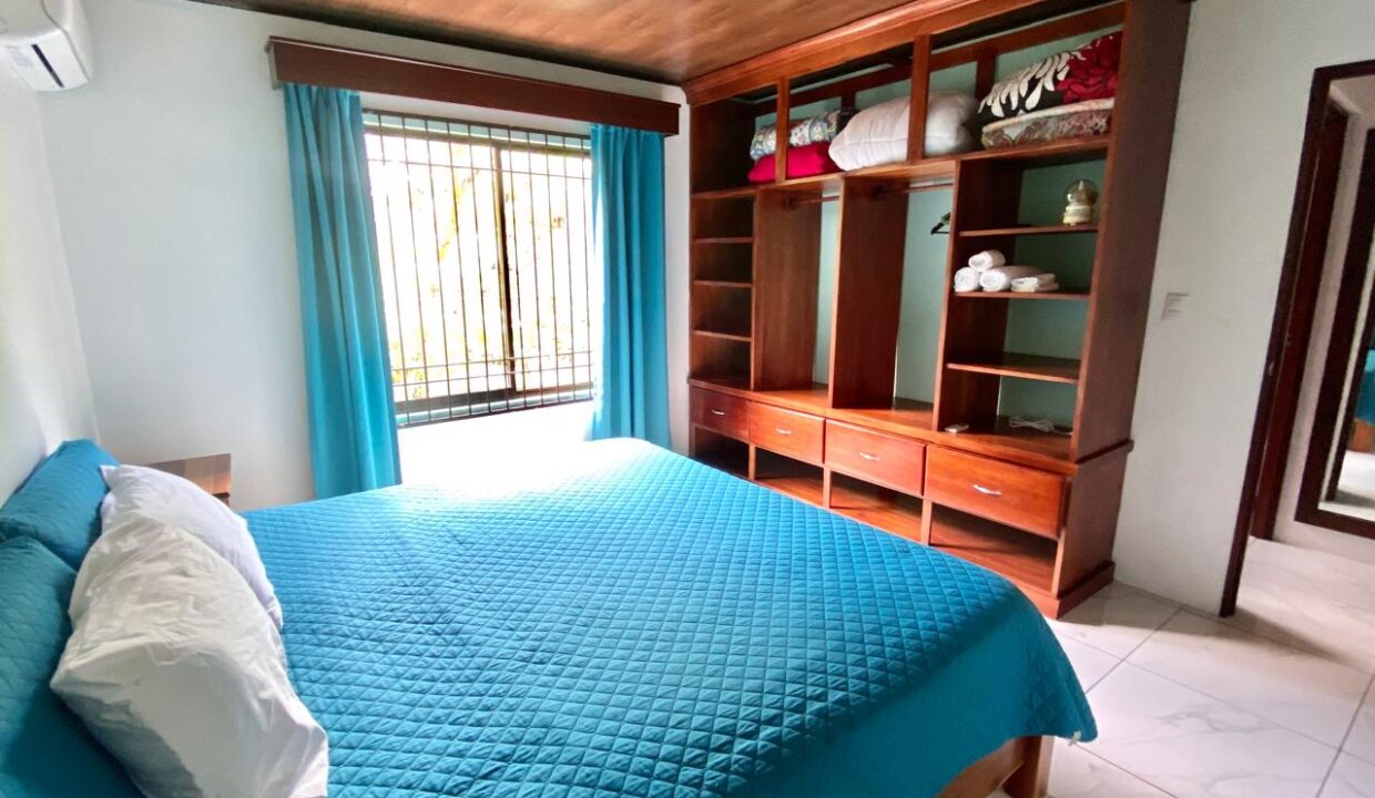 La Fortuna Costa Rica income property Elegant master suite with custom wood wardrobe in Jauuri rental home