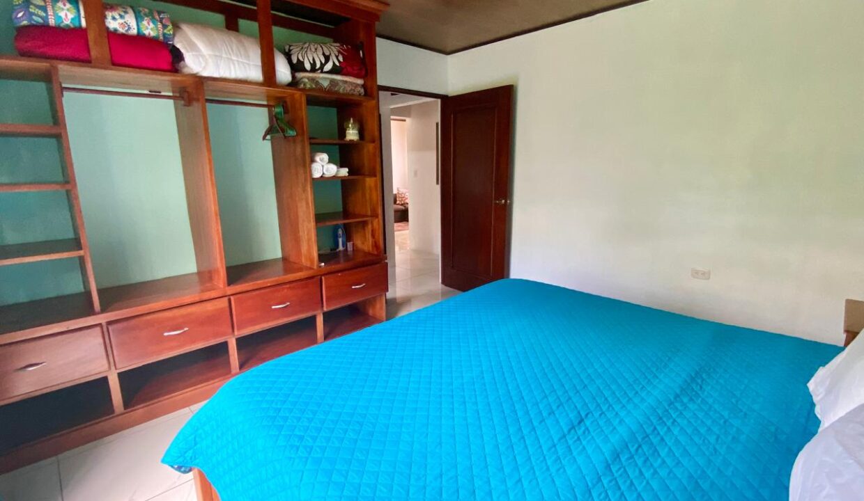 Cozy sleep space with blue comforter in Jauuri income home