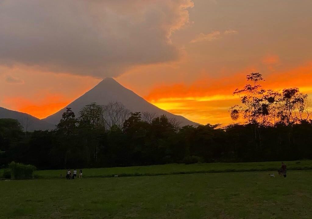 Arenal Volcano sunset view over green pasture, La Fortuna Costa Rica land