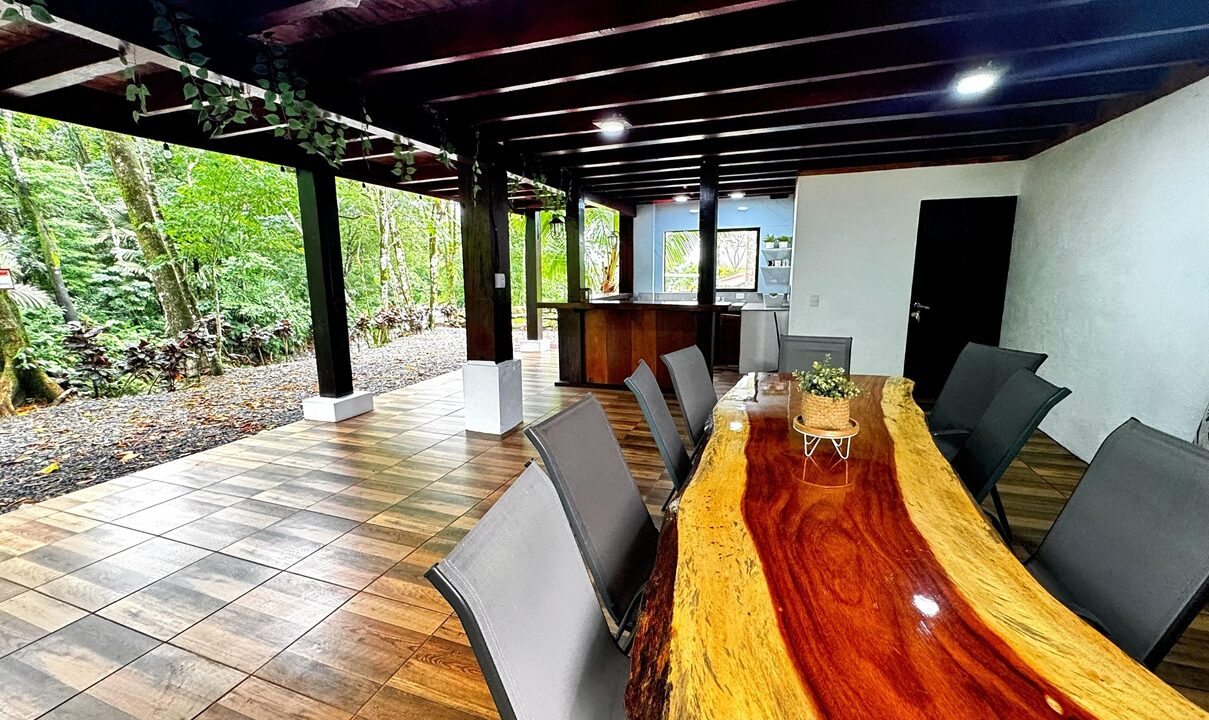 Rustic terrace in Costa Rica riverfront home for sale near La Fortuna with natural wood finishes and modern comfort.