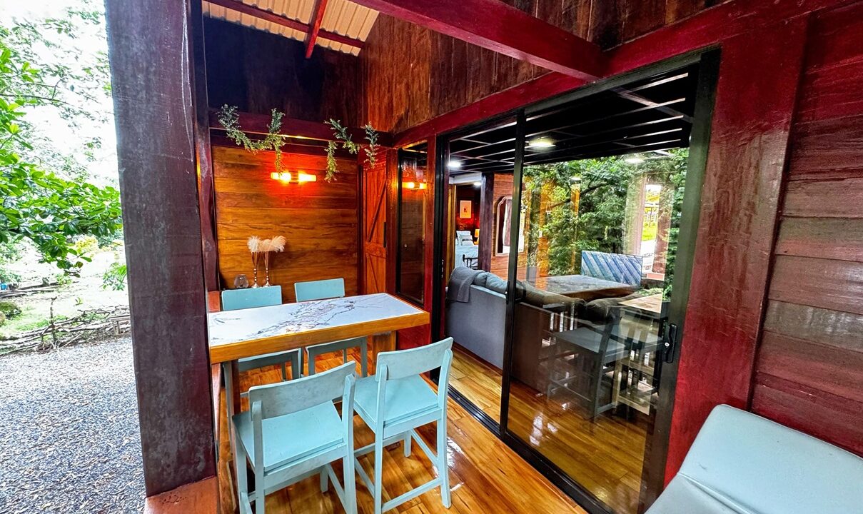 La Fortuna Costa Rica real estate with private river backyard. Two-story wooden house surrounded by lush nature perfect for Airbnb or family living.